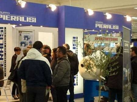 Piaralisi exhibition booth with attendees interacting at a trade show event. - Olive Oil Times