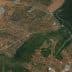 Aerial view showing an olive grove and diverse agricultural land with winding roads. - Olive Oil Times