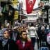 A bustling street in Turkey filled with people walking and shops lining the sides. - Olive Oil Times