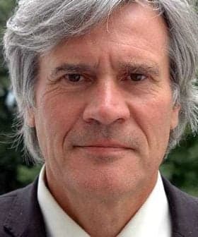 Close-up portrait of a man with gray hair wearing a suit and a neutral expression. - Olive Oil Times