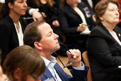 A diverse group of individuals seated in an audience during a conference or seminar event. - Olive Oil Times