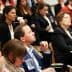 A diverse group of individuals seated in an audience during a conference or seminar event. - Olive Oil Times