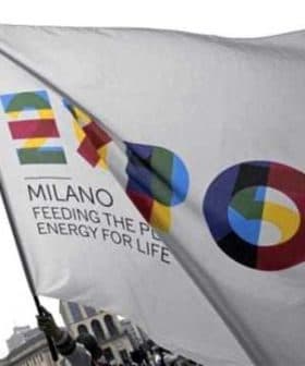 Flag featuring the Expo Milano logo with colorful graphics and the text 'Feeding the Planet, Energy for Life'. - Olive Oil Times