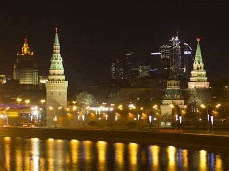 Night view of the Moscow Kremlin with illuminated towers and buildings along the river. - Olive Oil Times