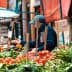 A market stall displaying various fresh vegetables including tomatoes, peppers, and greens. - Olive Oil Times