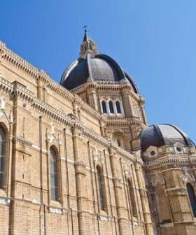 Close-up view of a historic building featuring large domes and intricate architectural details. - Olive Oil Times