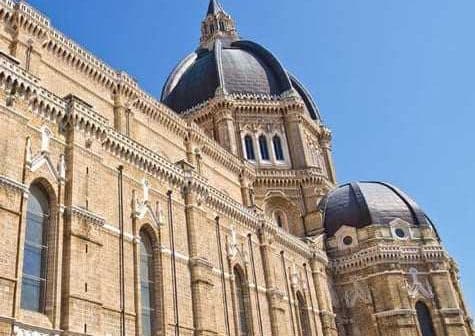 Close-up view of a historic building featuring large domes and intricate architectural details. - Olive Oil Times