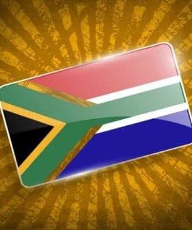 Graphic representation of the South African flag with a textured background. - Olive Oil Times