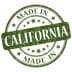 Green circular stamp with the text 'Made in California' and stars in a distressed style. - Olive Oil Times