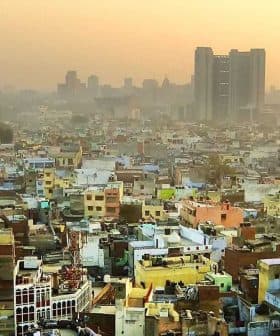 Aerial view of densely populated urban area in Delhi with buildings and rooftops visible. - Olive Oil Times