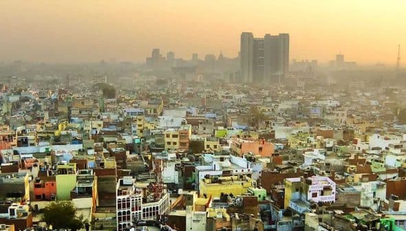 Aerial view of densely populated urban area in Delhi with buildings and rooftops visible. - Olive Oil Times