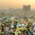 Aerial view of densely populated urban area in Delhi with buildings and rooftops visible. - Olive Oil Times