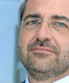 A man with glasses and a beard looking directly at the camera with a neutral expression. - Olive Oil Times