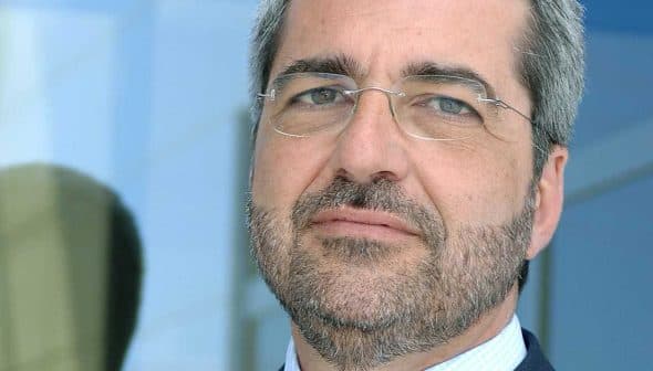 A man with glasses and a beard looking directly at the camera with a neutral expression. - Olive Oil Times