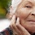 Elderly woman with gray hair and a thoughtful expression, resting her chin on her hand. - Olive Oil Times
