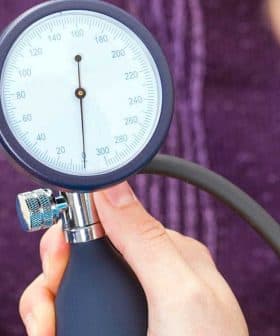 A healthcare professional measuring blood pressure with a sphygmomanometer on a patient's arm. - Olive Oil Times