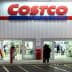Exterior view of a Costco Wholesale store with customers entering and exiting. - Olive Oil Times