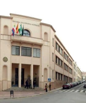 Two educational buildings in Jaén, featuring flags and distinct architectural styles. - Olive Oil Times