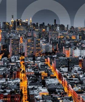 Aerial view of New York City skyline at night with illuminated buildings and streets. - Olive Oil Times