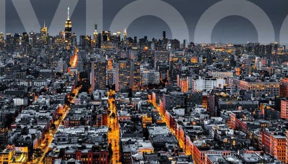 Aerial view of New York City skyline at night with illuminated buildings and streets. - Olive Oil Times