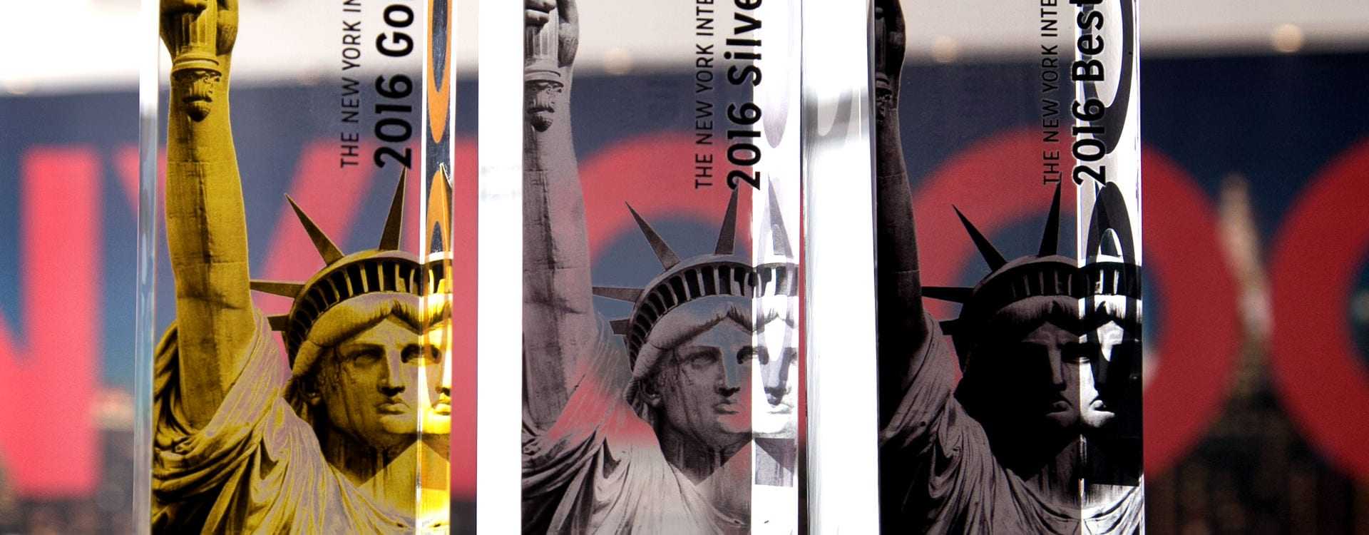 Three award trophies featuring the Statue of Liberty design for the 2016 New York International Olive Oil Competition. - Olive Oil Times