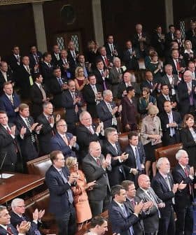 Members of the U.S. Congress standing and applauding during a session in the House chamber. - Olive Oil Times
