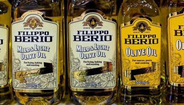 Three bottles of Filippo Berio olive oil labeled 'Mild & Light' and 'Olive Oil' on a shelf. - Olive Oil Times