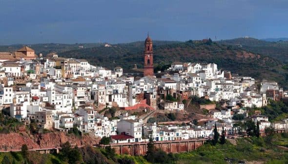 Panoramic view of Montoro, a village with white buildings and a prominent clock tower in the background. - Olive Oil Times