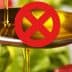 Spoon pouring olive oil with a red prohibition symbol overlaying the image. - Olive Oil Times