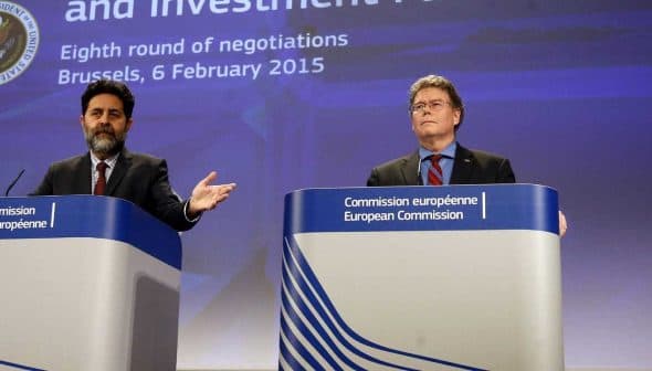 Two officials at a press conference discussing trade and investment negotiations in Brussels. - Olive Oil Times