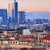 Panoramic view of Milan featuring modern skyscrapers and traditional buildings under a sunset sky. - Olive Oil Times