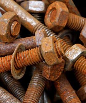 A collection of rusty bolts and nuts piled together in a disorganized manner. - Olive Oil Times