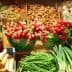 Assorted fresh vegetables including radishes, green beans, and avocados displayed at a market stall. - Olive Oil Times