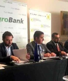 Panel of six individuals seated at a table during an AgroBank press conference. - Olive Oil Times