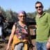 Two individuals posing for a photo in an olive grove during the olive harvesting process. - Olive Oil Times