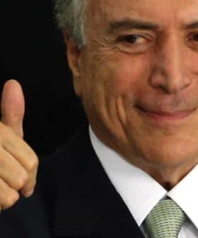 A man with gray hair and a suit giving a thumbs up gesture with a smile. - Olive Oil Times
