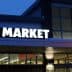 Exterior view of an ALDI food market with illuminated signage at dusk. - Olive Oil Times