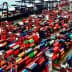 Aerial view of a container ship docked at a port surrounded by colorful shipping containers. - Olive Oil Times