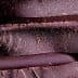 Close-up view of stacked layers of dark chocolate with a textured surface. - Olive Oil Times