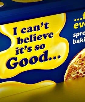 Container of a butter substitute with a yellow and blue design featuring text about its uses. - Olive Oil Times