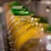 Bottles of olive oil being filled and capped in a production line. - Olive Oil Times