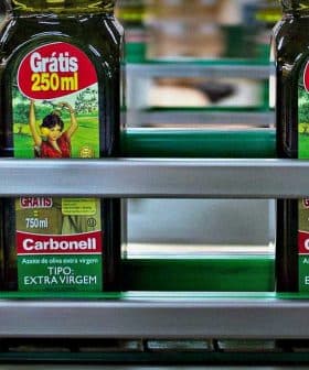 Bottles of Carbonell extra virgin olive oil labeled 250ml on a production line. - Olive Oil Times