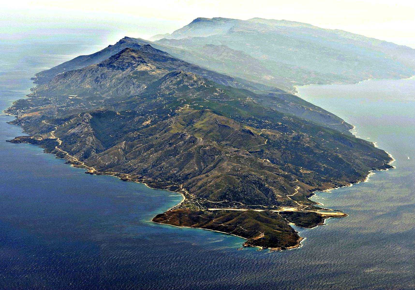 Aerial view of Ikaria Island showing mountainous terrain and coastal features. - Olive Oil Times
