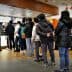 A group of people standing in line at a McDonald's restaurant waiting to order. - Olive Oil Times