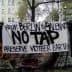 A protest banner reading 'From Berlin to Salento No Tap Preserve Mother Earth' displayed in an urban setting. - Olive Oil Times