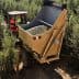 Tractor with a large trailer collecting olives in an olive grove. - Olive Oil Times