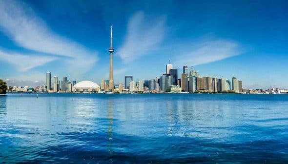 Panoramic view of Toronto skyline featuring the CN Tower and waterfront. - Olive Oil Times