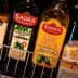 Various bottles of olive oil displayed on a shelf, including brands like Sagras and Borges. - Olive Oil Times