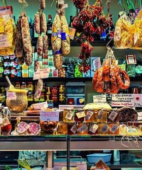 A market display featuring various food products including pasta, meats, and preserves. - Olive Oil Times