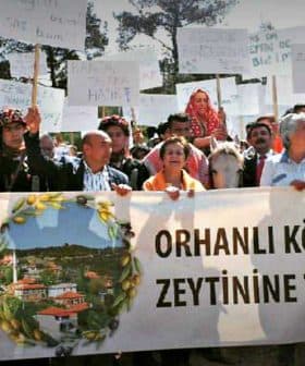 Group of protesters holding banners and signs during a demonstration in Orhanlı Village against a quarry operation. - Olive Oil Times